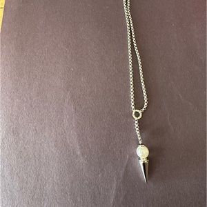 Costume jewelry silver necklace with silver spike and iridescent ball pendant